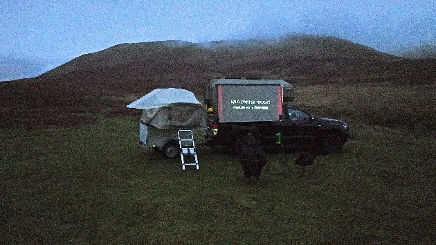 An outdoor cinema build into the side of a 4x4