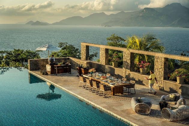 A dining table and seating area surrounded by the sea