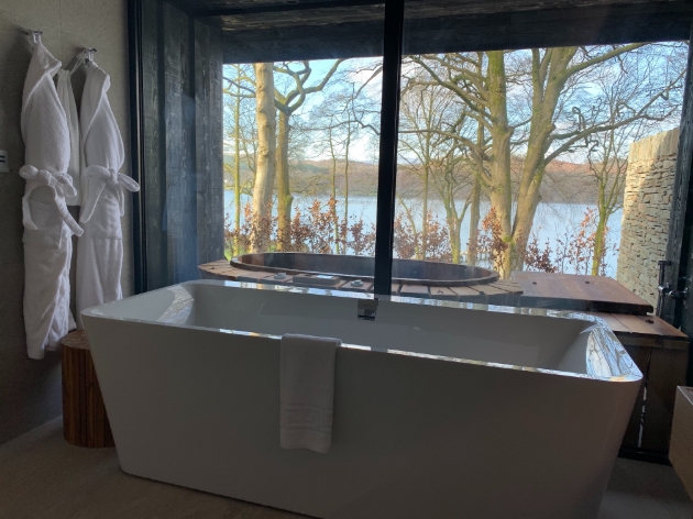 A bathtub overlooking a lake